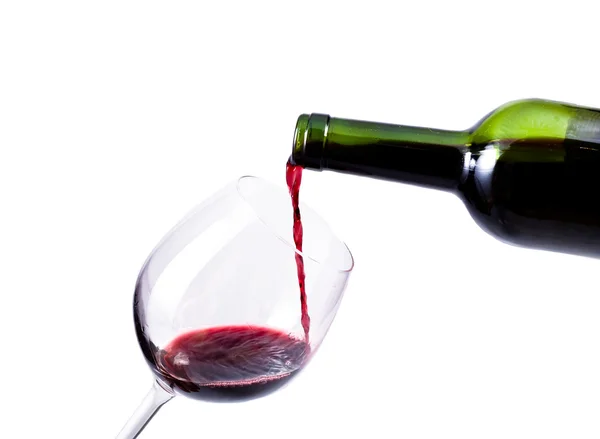 Красное вино, наливаемое в бокал Стоковая Картинка