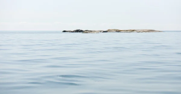 Islote y mar tranquilo —  Fotos de Stock