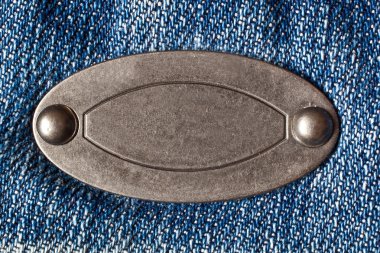 denim arka plan üzerine metal oval