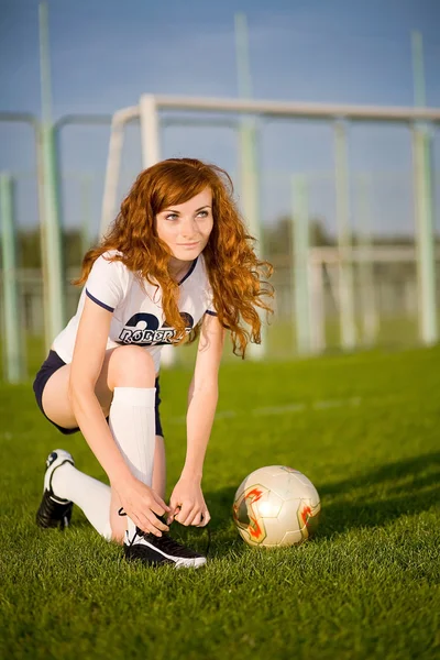 Healthy beautiful girl with freckles on soccer field — Stock Photo, Image
