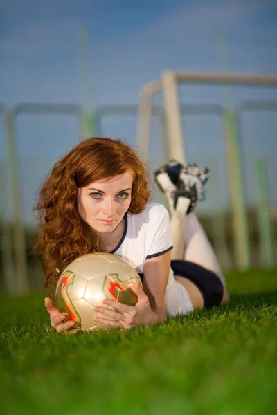 Healthy beautiful girl with freckles on soccer field — Stock Photo, Image
