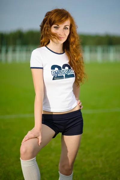Healthy beautiful girl with freckles on soccer field — Stockfoto