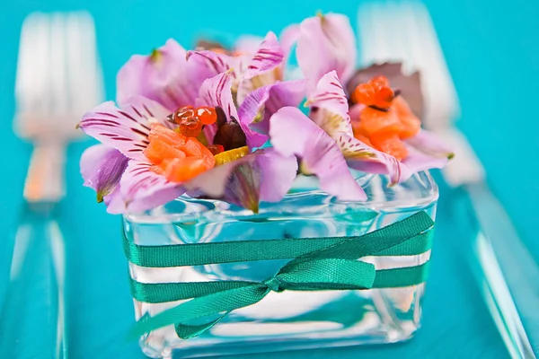 stock image Flowers in a glass dish with slices of fish