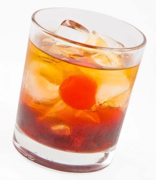 A delicious glass of whiskey with ice cubes and cherry — Stock Photo, Image