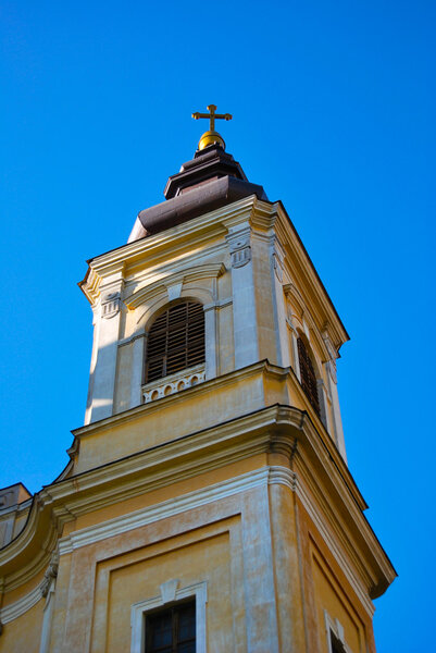 Catholic church tower on the blue sky