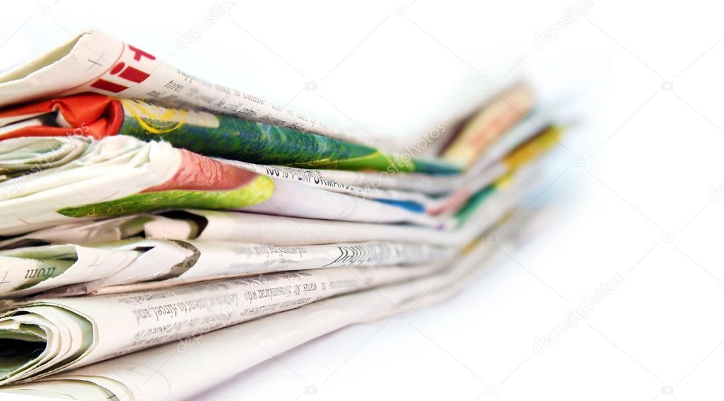 Newspapers stacked against a white background