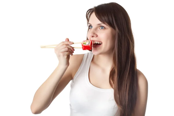Young woman is eating sushi — Stock Photo, Image