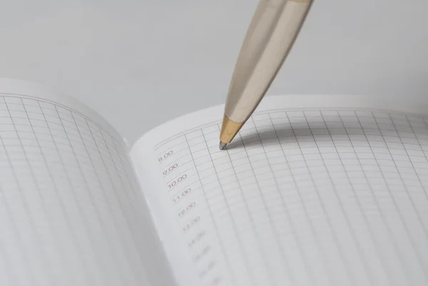 Pen writing in a notebook — Stock Photo, Image