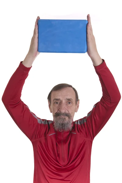 Holding yoga block between hands above head — Stock Photo, Image
