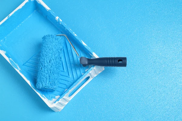 Roller with blue paint — Stock Photo, Image