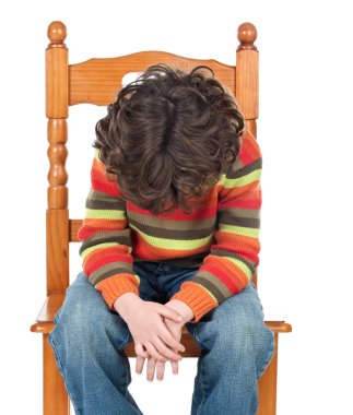 Sad child sitting on a chair isolated clipart