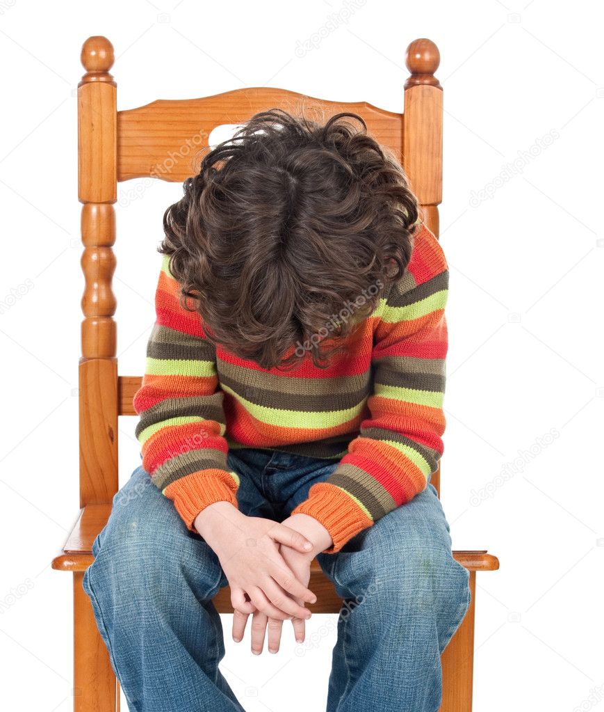 Sad child sitting on a chair isolated