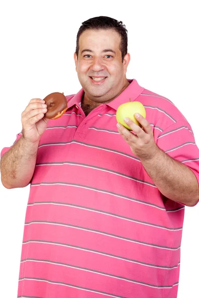 Hombre gordo decidiendo entre un caramelo y una manzana — Foto de Stock
