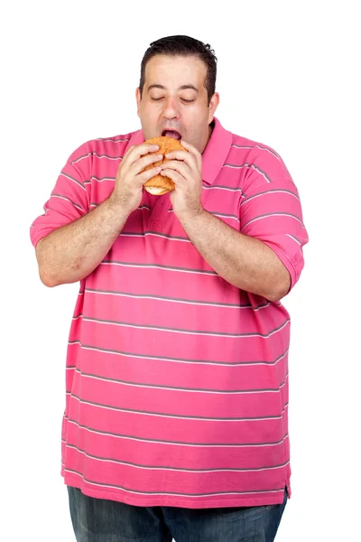 Fat man eating a hamburger — Stock Photo, Image