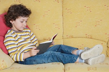 Adorable boy reading clipart