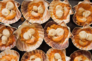 Baking tray of scallops cooked clipart