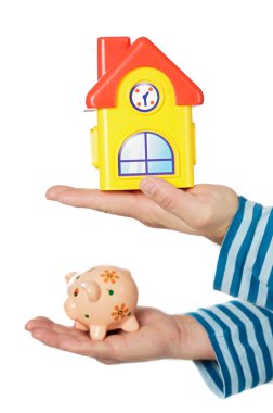 House and moneybox in hands clipart