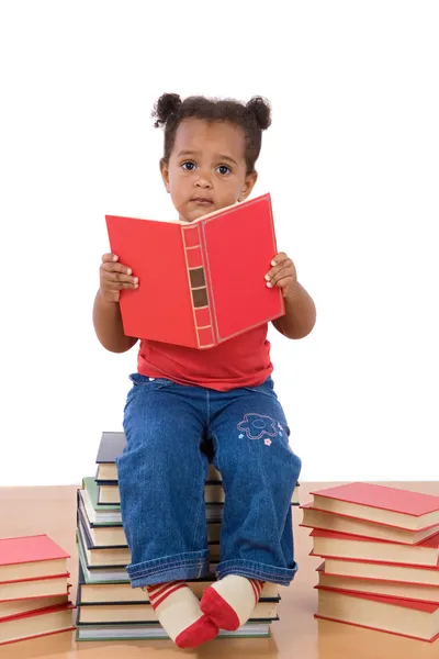 Baby reading sitting on a pile of books — Stock Photo, Image