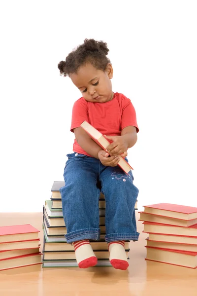 Детское чтение сидя на куче книг — стоковое фото