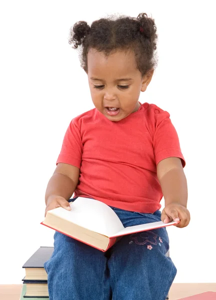 Baby reading sitting on a pile of books — Stock Photo, Image