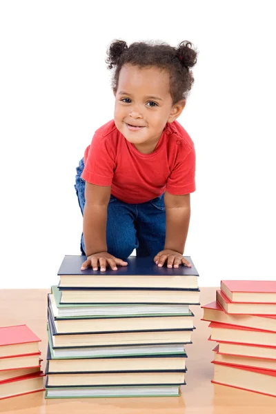 Escalade bébé sur un tas de livres — Photo
