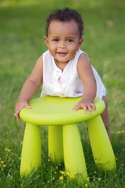 Toddler playing with chair — Stock Photo, Image