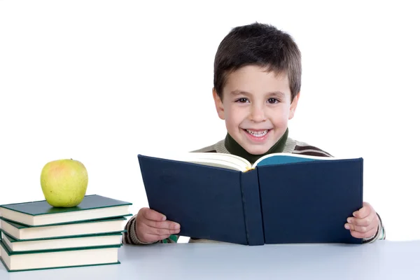 Criança adorável estudando com livros e maçã — Fotografia de Stock