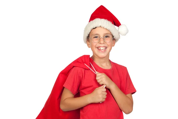 Αξιολάτρευτο παιδί με το καπέλο santa ψάχνει στο τσουβάλι — Φωτογραφία Αρχείου