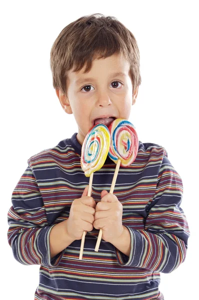 Child eating two lollipops — Stock Photo, Image
