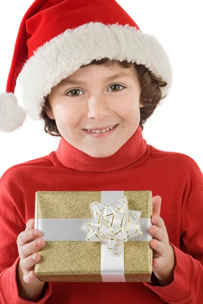 Entzückender Junge mit rotem Weihnachtsmütze und einem Geschenk — Stockfoto