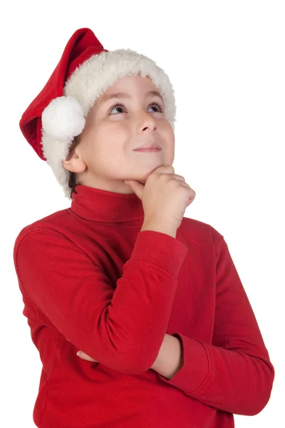 Adorabile ragazzo con cappello di Babbo Natale pensando — Foto Stock