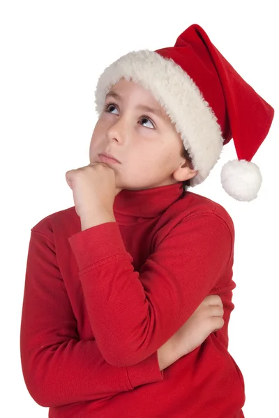 Adorable boy with santa hat thinking — Stock Photo, Image