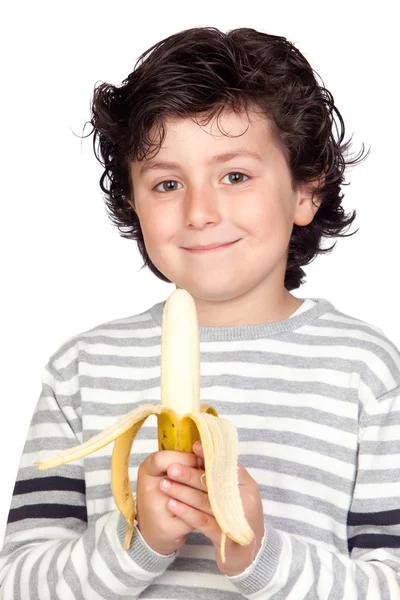 Beautiful child eating a banana — Stock Photo, Image