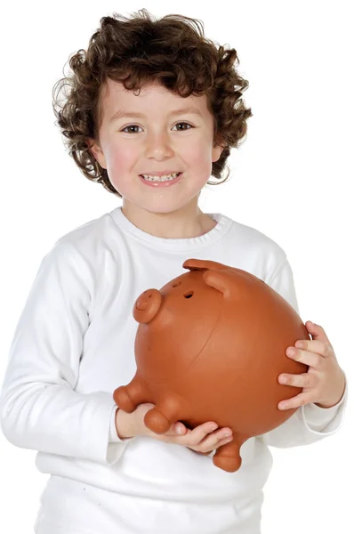 Urocze dziecko z jego oszczędności w jej polu pieniądze świnka — Zdjęcie stockowe