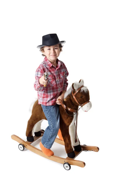 Criança adorável montando um cavalo de brinquedo — Fotografia de Stock