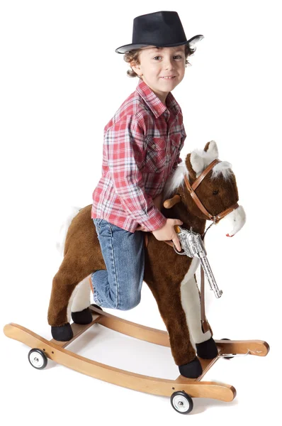 Menino adorável jogando cowboys com um cavalo de madeira — Fotografia de Stock