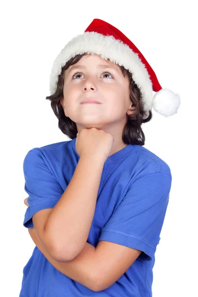 Nachdenkliches Kind mit Weihnachtsmütze — Stockfoto