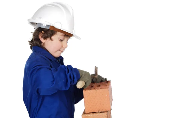 Adorable future builder constructing a brick wall — Stock Photo, Image