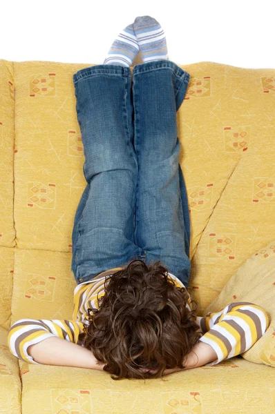 stock image Boy lying down on the sofa at home