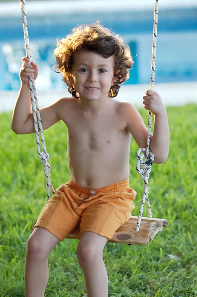 Beautiful child in swing — Stock Photo, Image