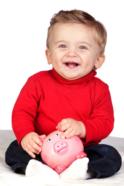 Schönes blondes Baby mit Sparschwein — Stockfoto