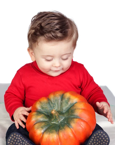 Beautiful blond baby with a big pumpkin — Stock Photo, Image