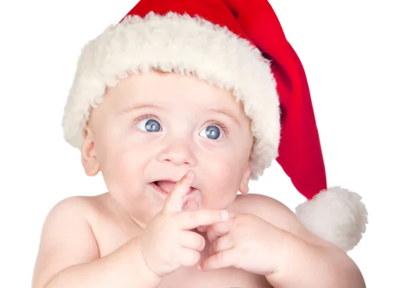 Красивая малышка с голубыми глазами и рождественской шляпой — стоковое фото
