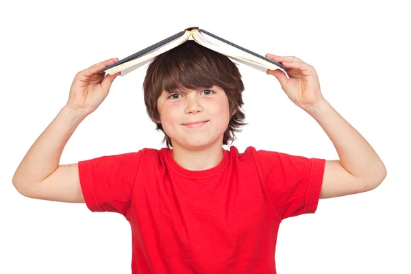 Student child with a book over his head — Stock Photo, Image
