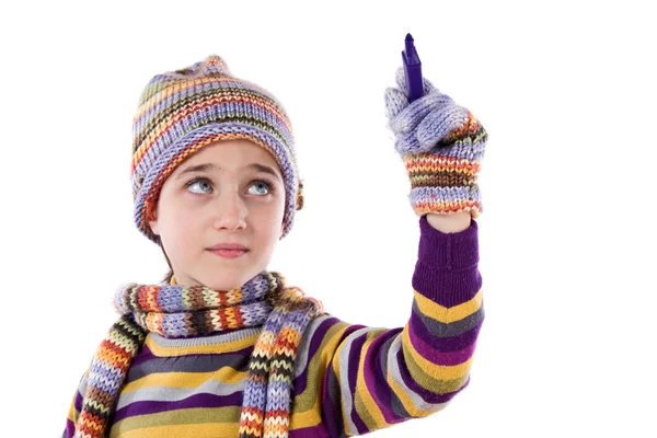 Adorable little girl with clothes for the winter writing — Stock Photo, Image