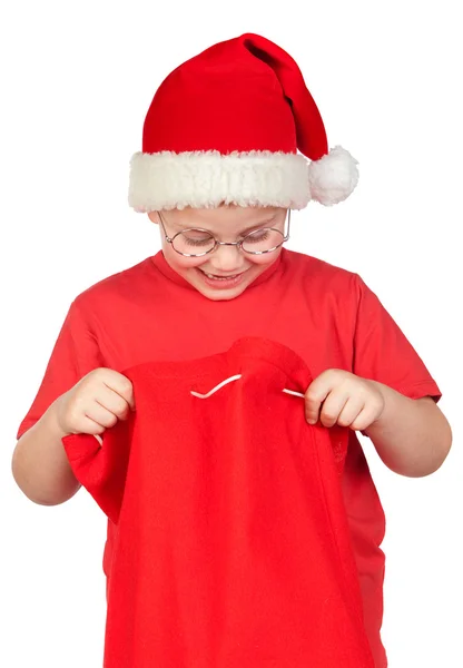 Criança adorável com chapéu de Santa olhando no saco — Fotografia de Stock