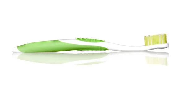 stock image Green toothbrush with reflection on the floor