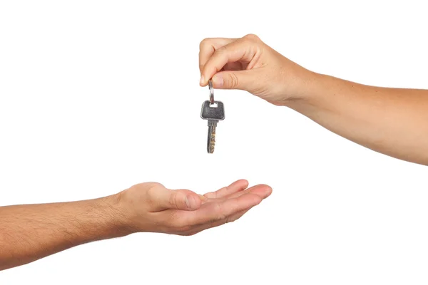 Hand giving a key — Stock Photo, Image