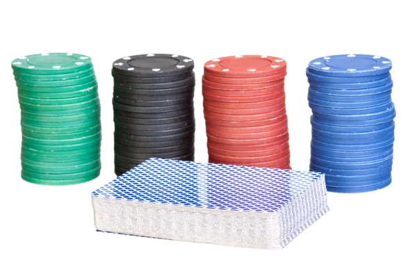 Deck of cards with four stacks of poker chips — Stock Photo, Image