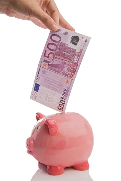 Saving a note of five hundred euros in a piggy-bank — Stock Photo, Image